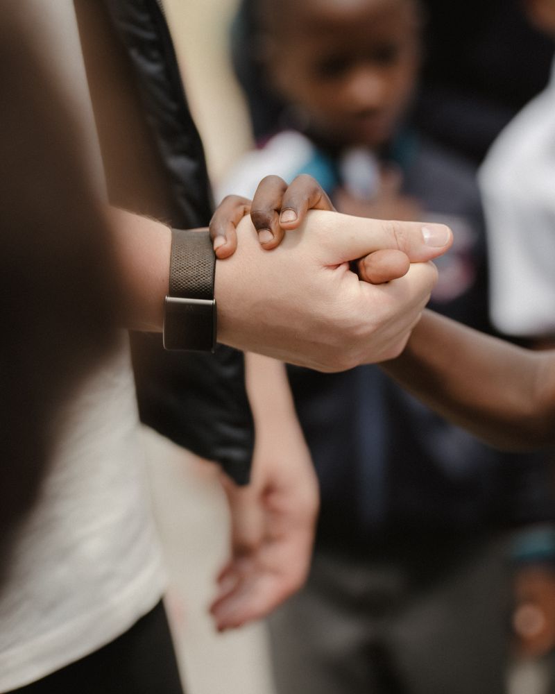 A child’s hand holding an adult’s hand.